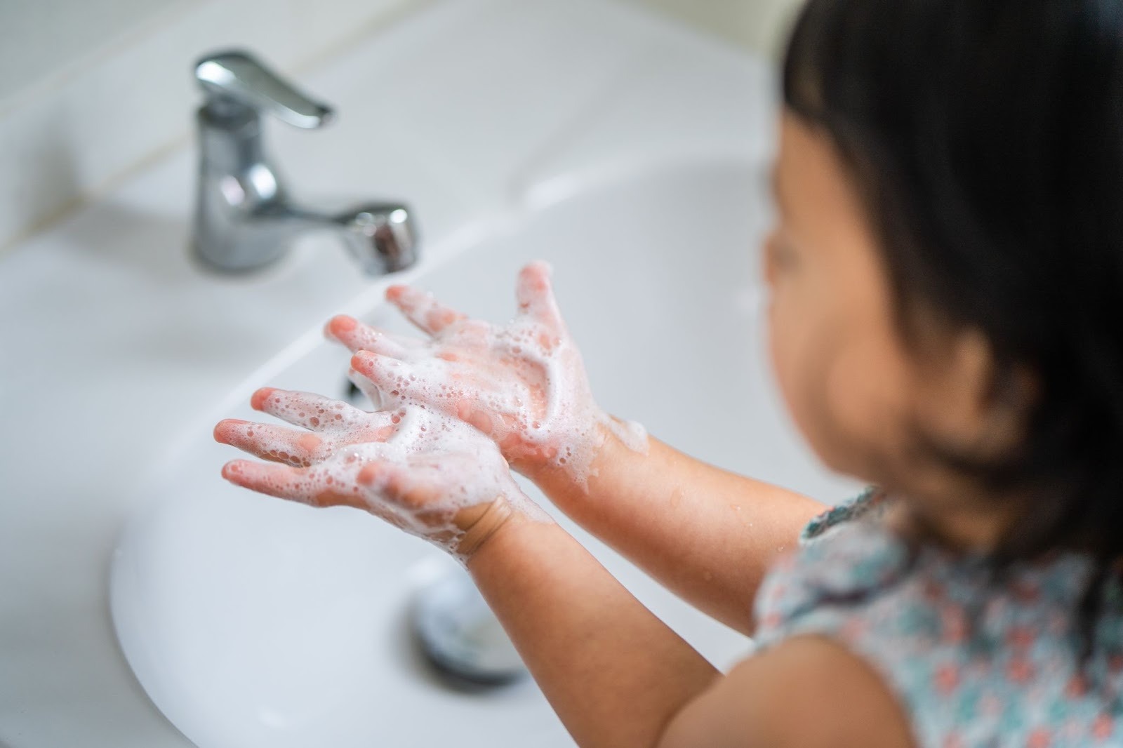 A little girl washing her hands