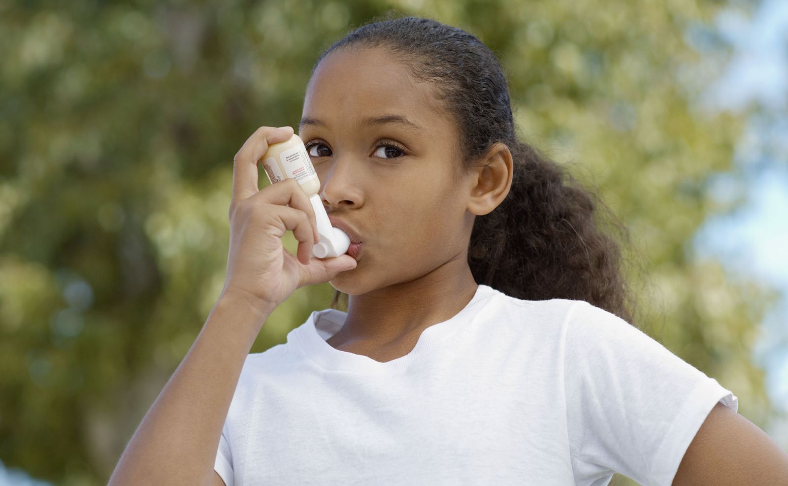 a girl using inhaler